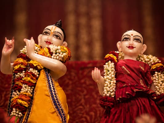 Devotees spending peaceful time in a devotional home setting